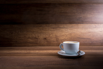 Cup of cappuccino on a wood background