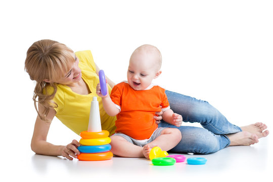 baby boy and mother play together with toy