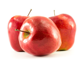 Three fresh red apples with drops isolated on white