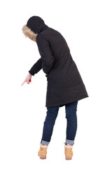 Naklejka premium Back view of pointing young women in parka..