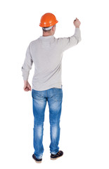 back view of writing engineer in construction helmet.