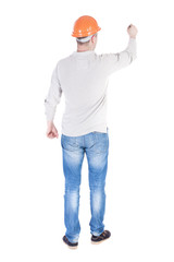 back view of writing engineer in construction helmet.