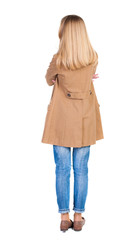 back view of standing young beautiful  blonde woman in brown clo