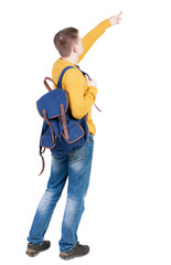 Back view of  pointing young men with backpack.