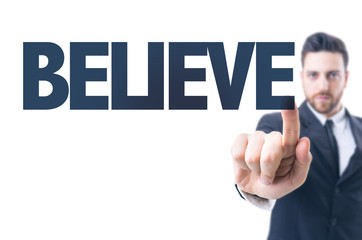 Business man pointing the text: Believe