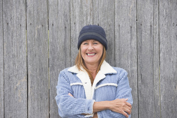 Happy woman warm jacket timber background