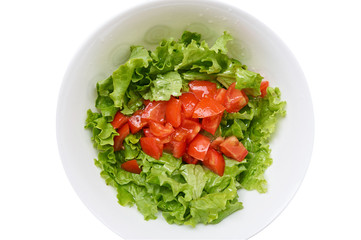 Healthy green salad, tomatoes in white bowl. Isolated on white.