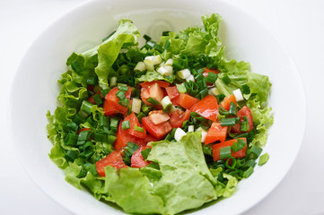 Healthy green salad, in white bowl.