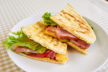 Grilled panini sandwiches stuffed with ham and cheese