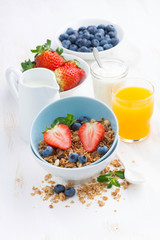 healthy breakfast - granola, fresh berries, orange juice