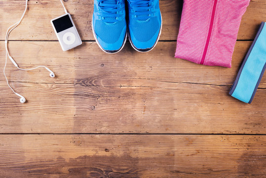 Various running stuff lined up on a wooden floor background