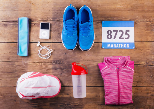 Various running stuff lined up on a wooden floor background