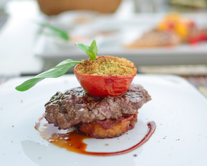 Beef Steak on french fries with baked tomatoes