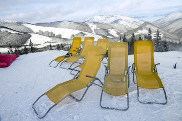 chaise lounges in winter resort