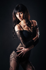 Fototapeta premium Sexy beautiful naked woman in black erotic lingerie on dark