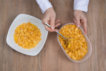 Cornflakes in porcelain bowl isolated on white background