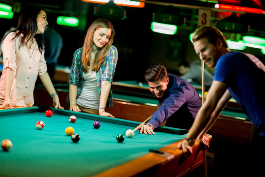 Young people playing pool