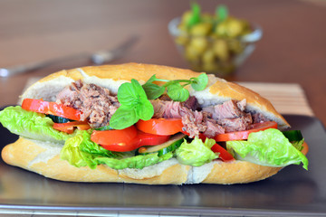 Tuna Baguette With Vegetables On The Brown Plate