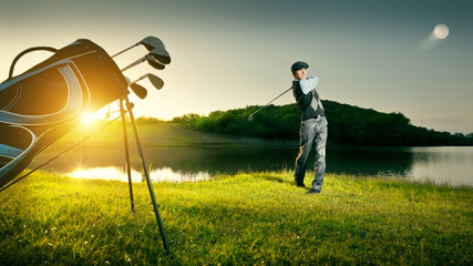 Golf. Golfer makes a strong kick of the ball.