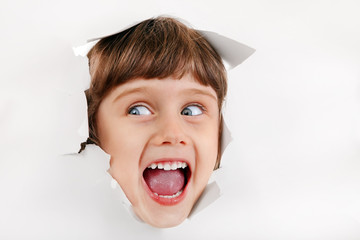 Little Girl Face through the Paper Hole