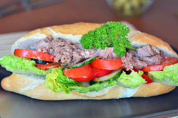 Tuna Baguette With Vegetables On The Brown Plate