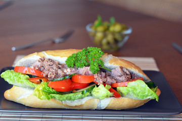 Tuna Baguette With Vegetables On The Brown Plate