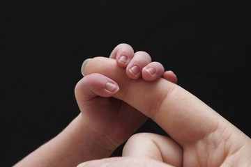 Mother and infant hand