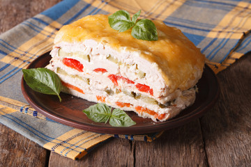 Chicken pie with vegetables on a plate close-up