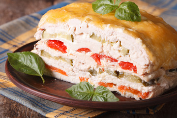 Cut chicken pie with vegetables on a plate close-up. horizontal