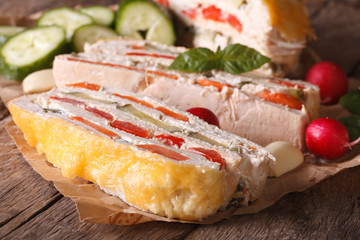 Sliced chicken casserole and fresh vegetables
