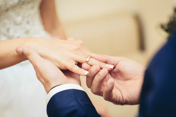 Obraz na płótnie Canvas groom placing an engagement ring
