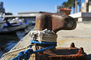 ropes tied on a rusty mooring
