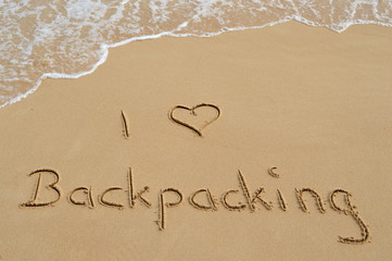 Text 'I love Backpacking' in the sand