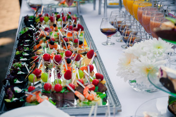 a lot of cold snacks on buffet table, catering