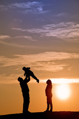 silhouette of family on the outdoor at dusk