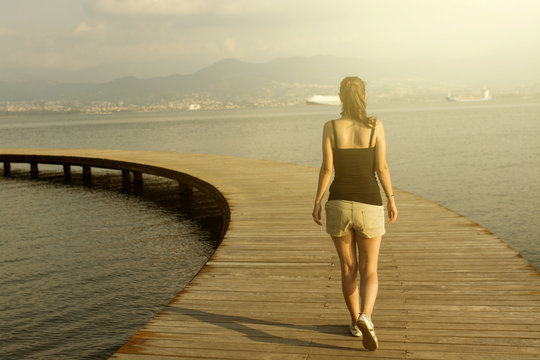 Woman Walking On Pier