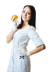 Beautiful caucasian doctor or nurse holding an orange. Isolated