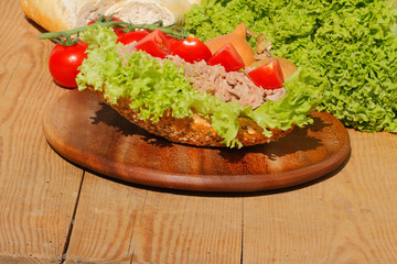 Fischbrötchen mit Thunfischfilet, Salat, Gewürzgurken, Zwiebeln