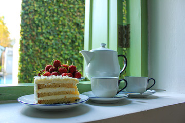 Tea time with Strawberry, cake and hot tea.