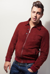 Elegant young handsome man in claret suede jacket.