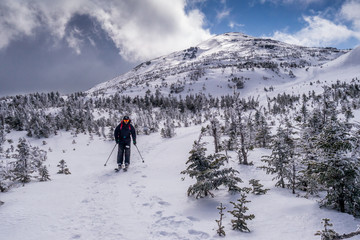 back country skier on mountain summit