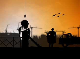 silhouette engineer looking at blueprints in a building site ove