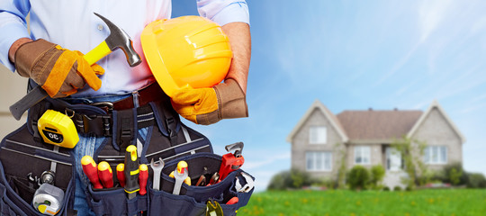 Builder handyman with construction tools.