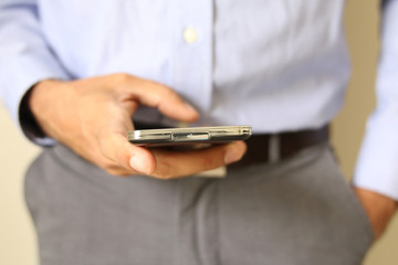 Close up of a man using mobile smart phone