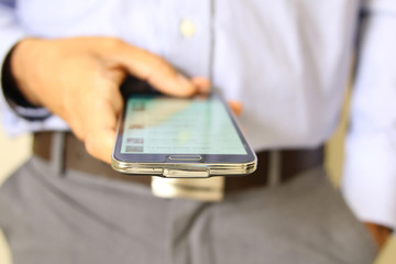 Close up of a man using mobile smart phone