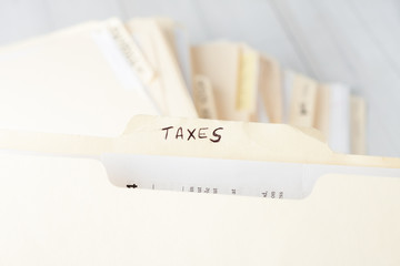 yellow paper folder labeled TAXES
