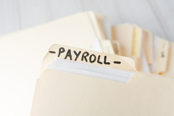 yellow paper folder labeled PAYROLL
