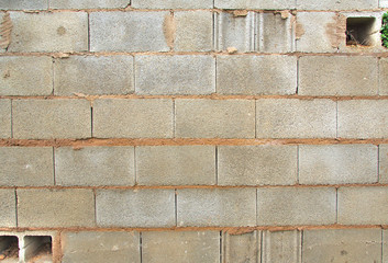 Old and broken grey brick wall