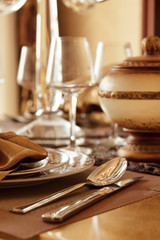 A soft toned image of a table setting with plate, napkin and utensils