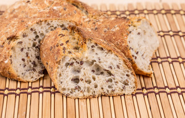 Brown bread with seeds on a table.